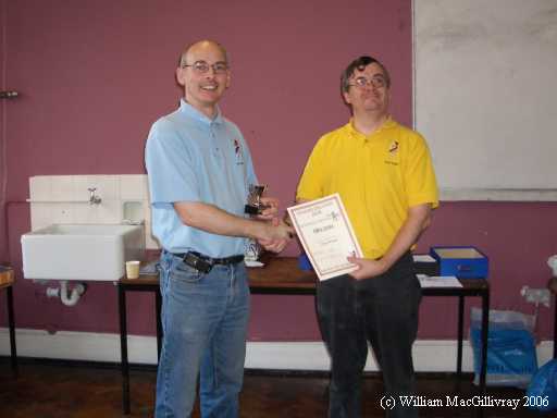 Richard Jeffrey-Cook (left) receiving his trophy and prize